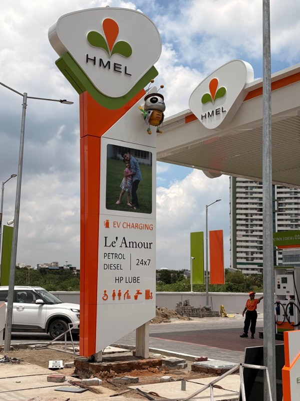 Photograph of an orange and white roadside pylon carrying the three-petal logo