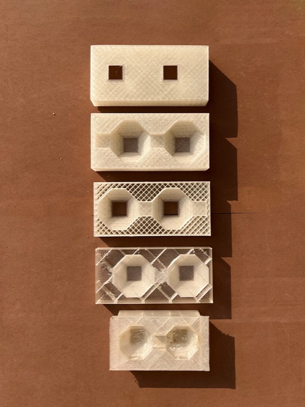 Five white 3D-printed moulds in a column, each with a different pattern of openings
