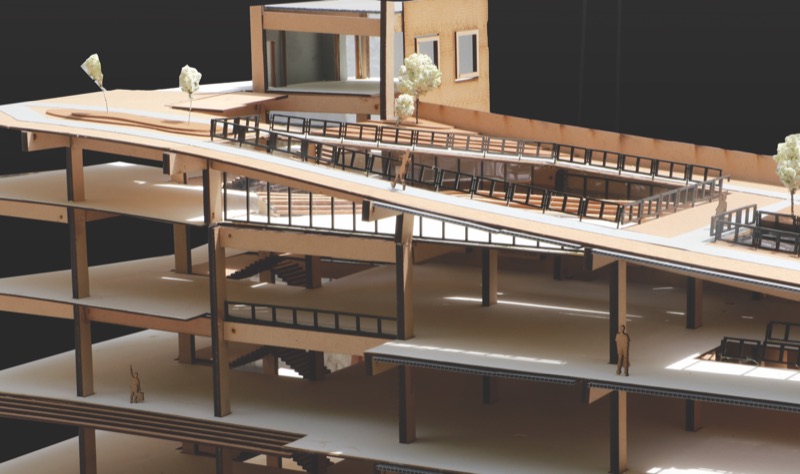 Wooden sectional model showing floors, columns and a sloping roof deck